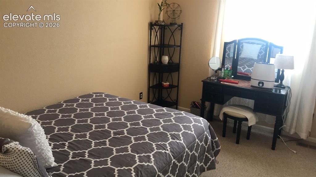 Image 5 of 10: Wall-to-wall carpeting and neutral wall tones