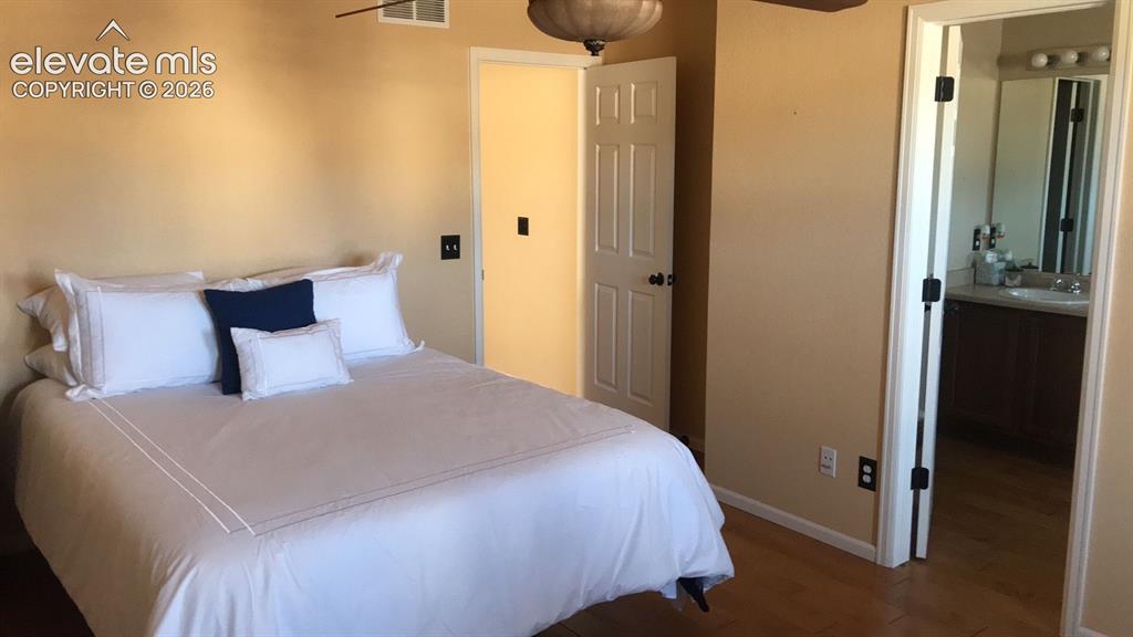 Image 6 of 10: Wood-finish flooring with neutral wall tones