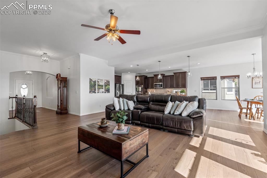 Image 10 of 48: Living area featuring hanging lights, light wood-style flooring, a ceiling