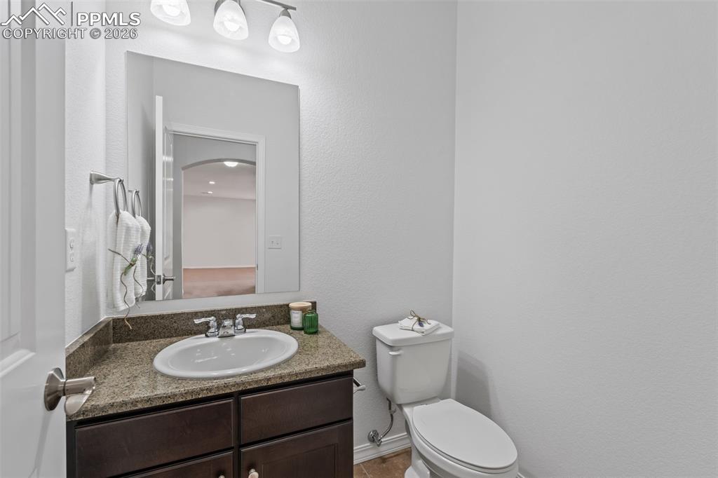 Image 34 of 48: Half bath featuring vanity and a textured wall