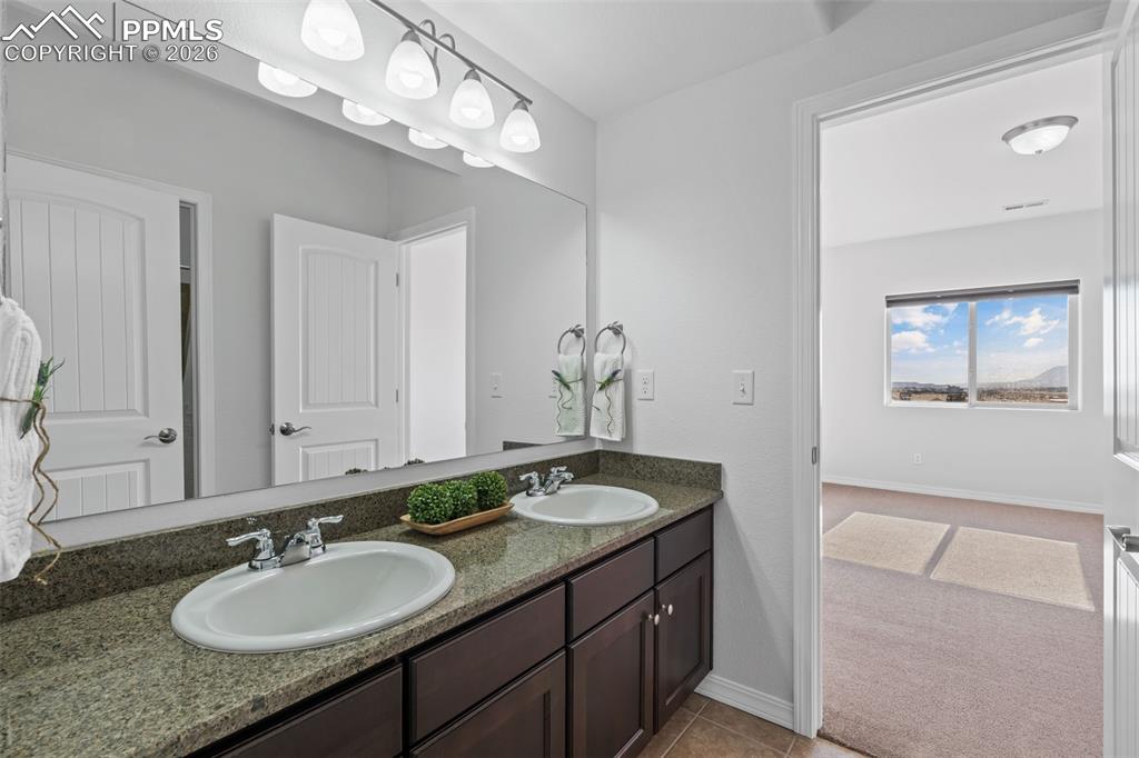 Image 37 of 48: Bathroom featuring double vanity and light colored carpet
