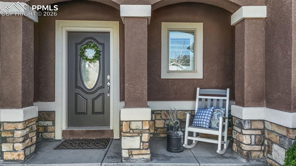 Image 4 of 48: Property entrance with stucco siding
