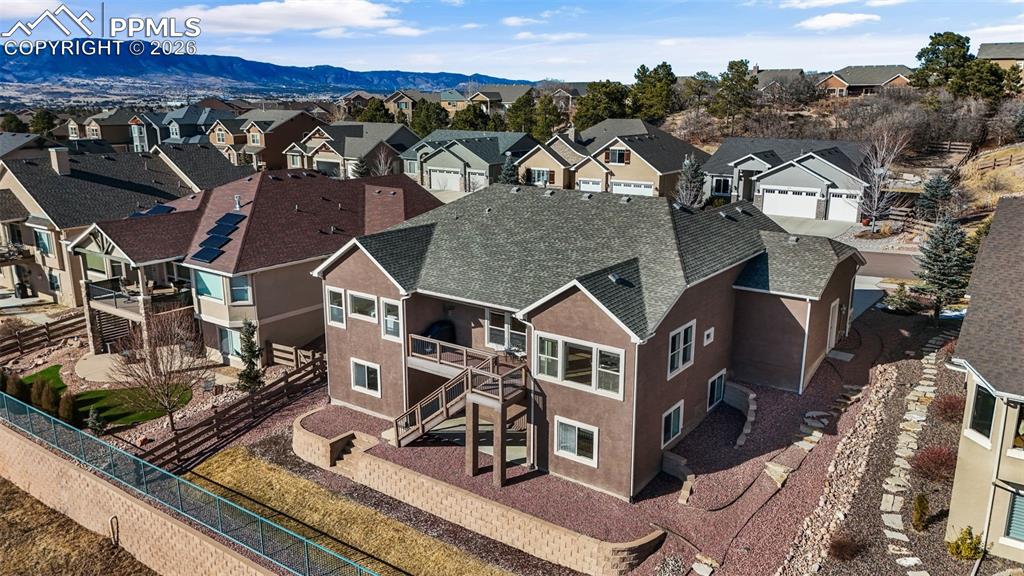 Image 40 of 48: Aerial view of residential area with a mountain backdrop