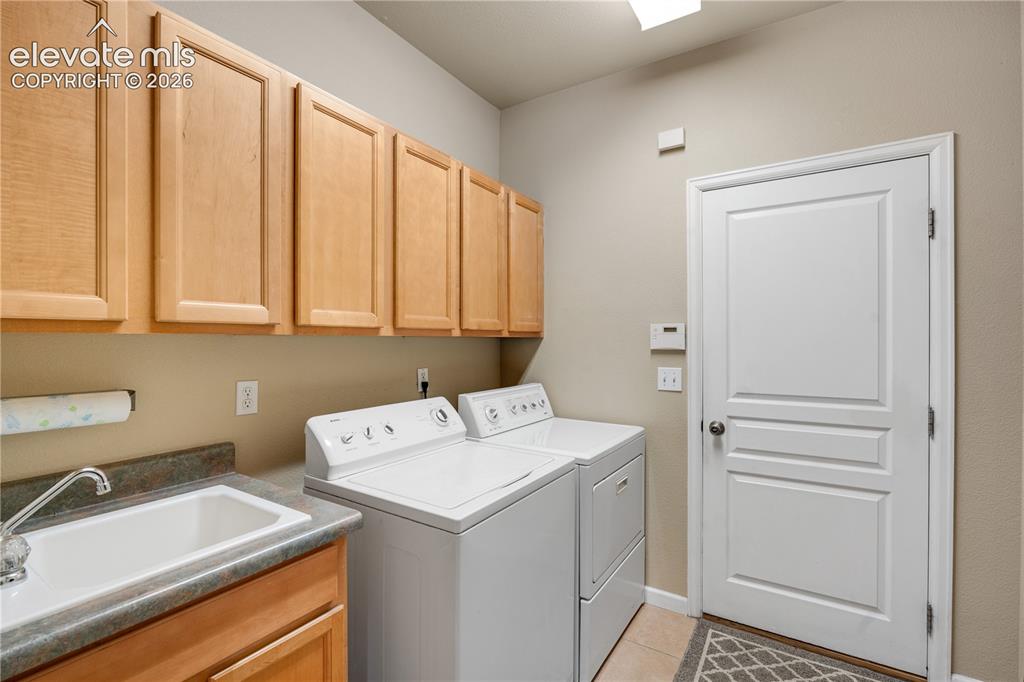 Image 18 of 25: Main level laundry & wash sink