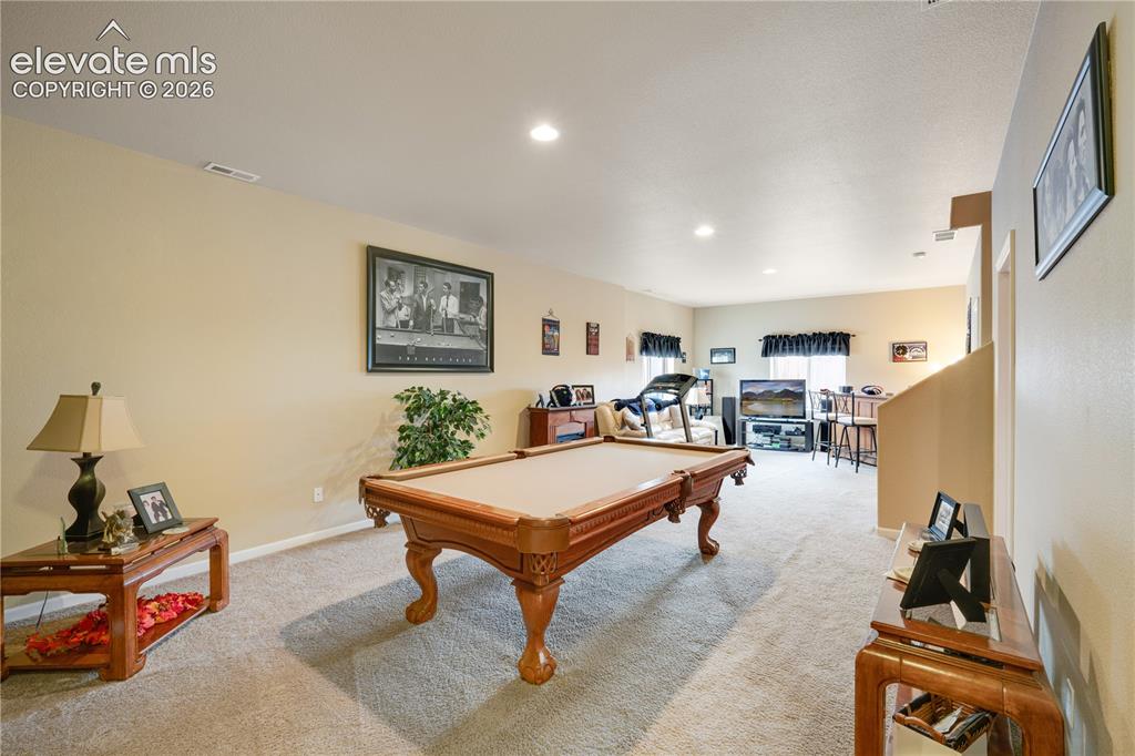 Image 22 of 25: Family room/multipurpose area in basement with high ceilings!!!