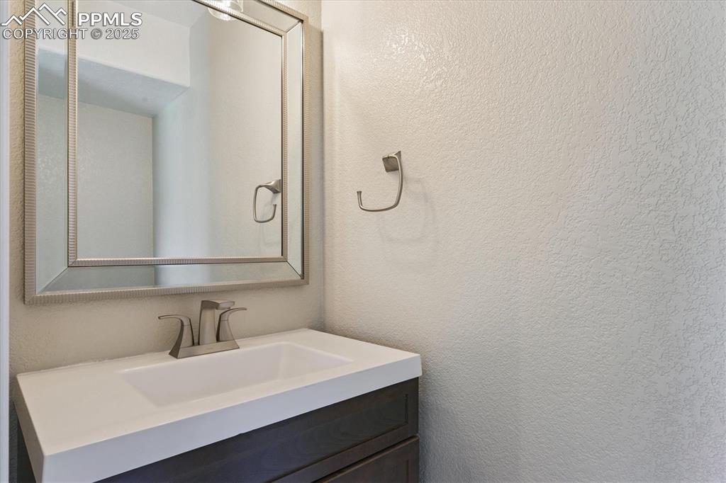 Image 7 of 14: Bathroom featuring vanity and a textured wall