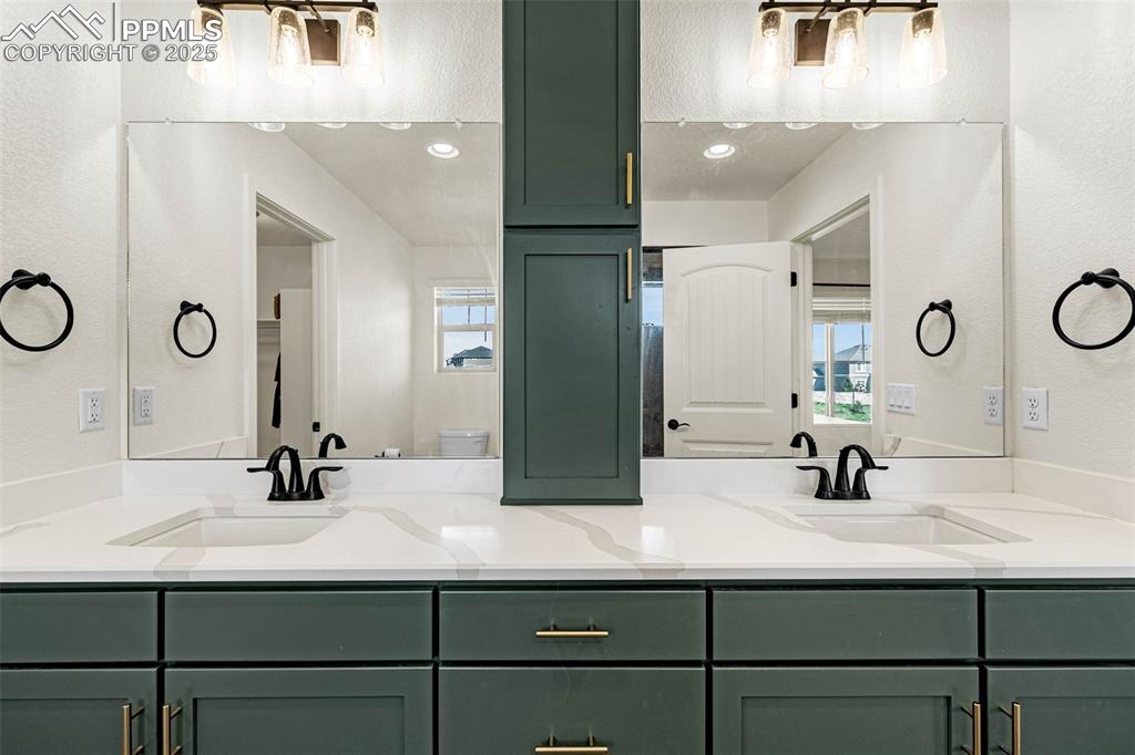 Image 15 of 32: Full bath featuring a textured wall and double vanity