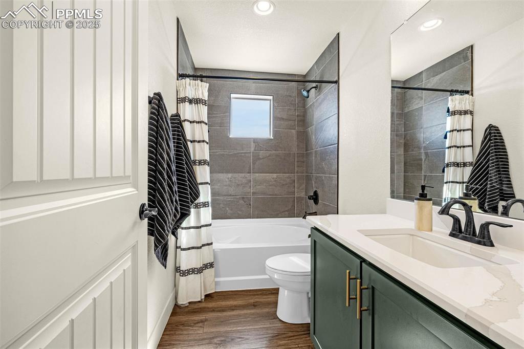Image 19 of 32: Full bathroom featuring vanity, shower / bathtub combination with curtain,