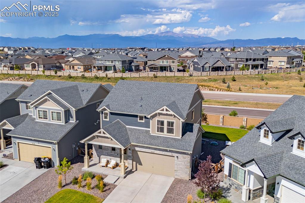 Image 29 of 32: Aerial view of residential area with mountains