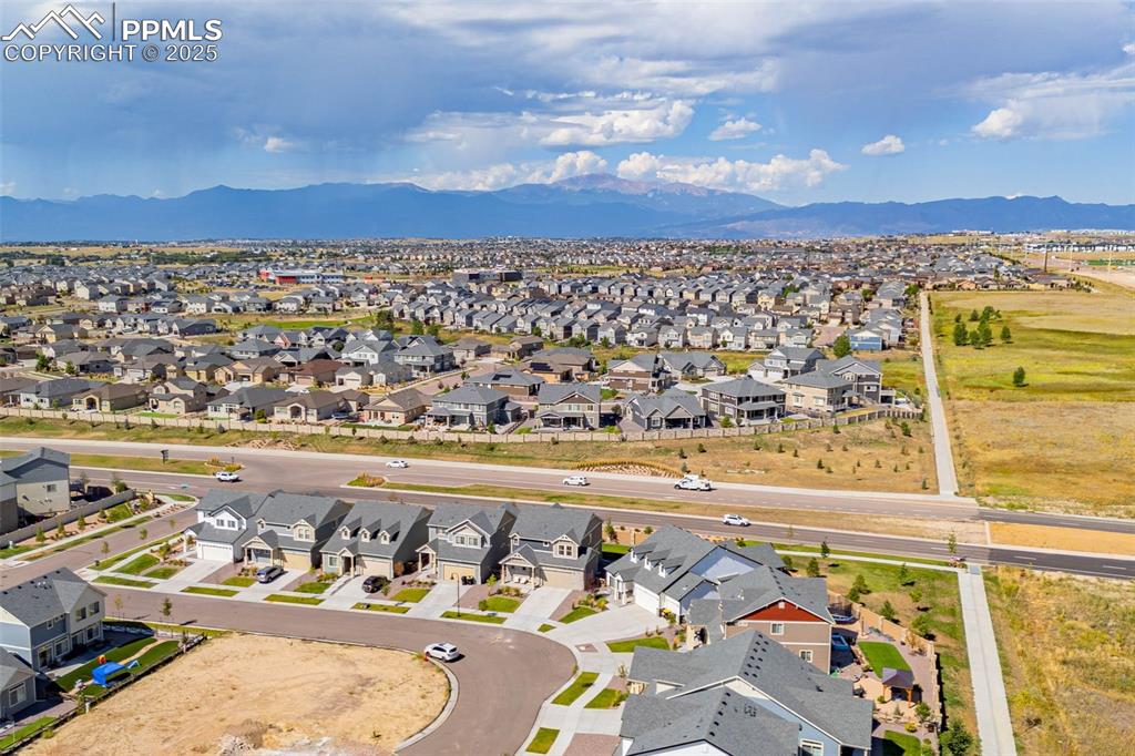 Image 31 of 32: Aerial view of residential area with a mountain backdrop