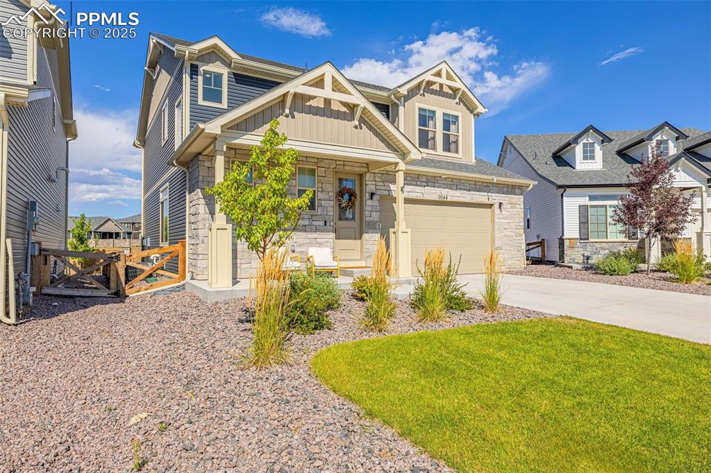 Image 6 of 32: Craftsman-style house with stone siding, board and batten siding, an attach
