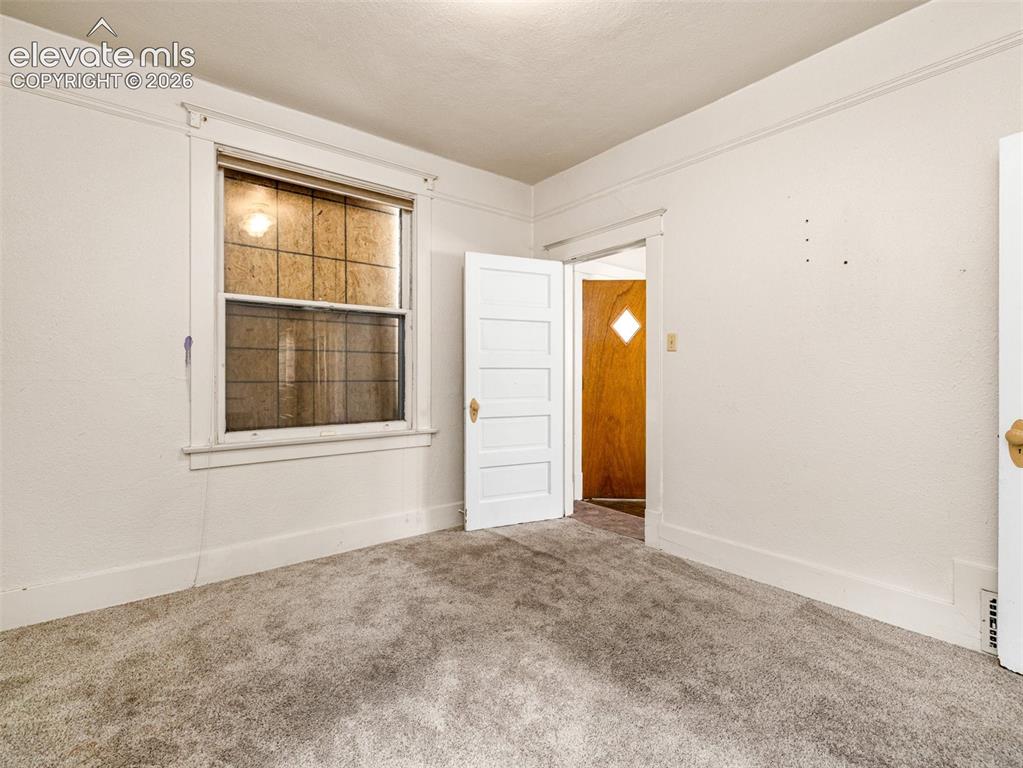 Image 10 of 22: Wall-to-wall carpeting and white painted walls