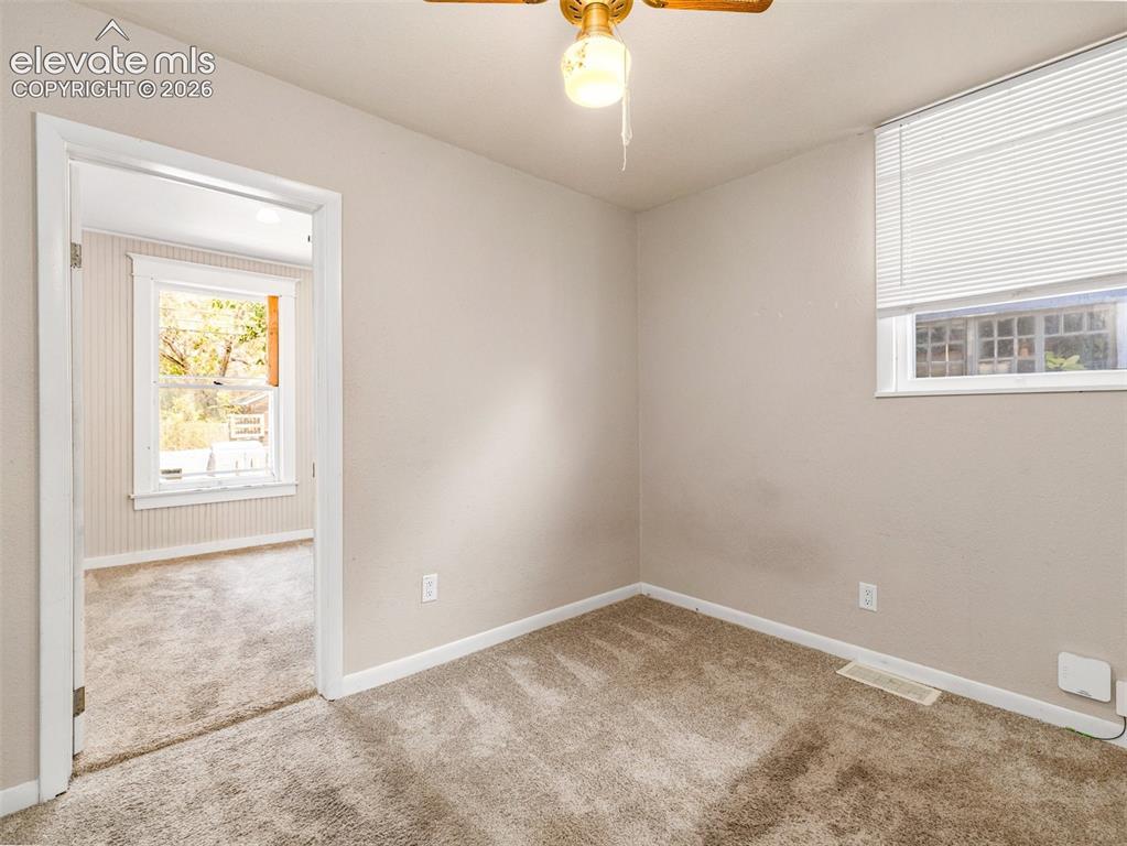 Image 13 of 22: Neutral tone wall finish with carpet flooring