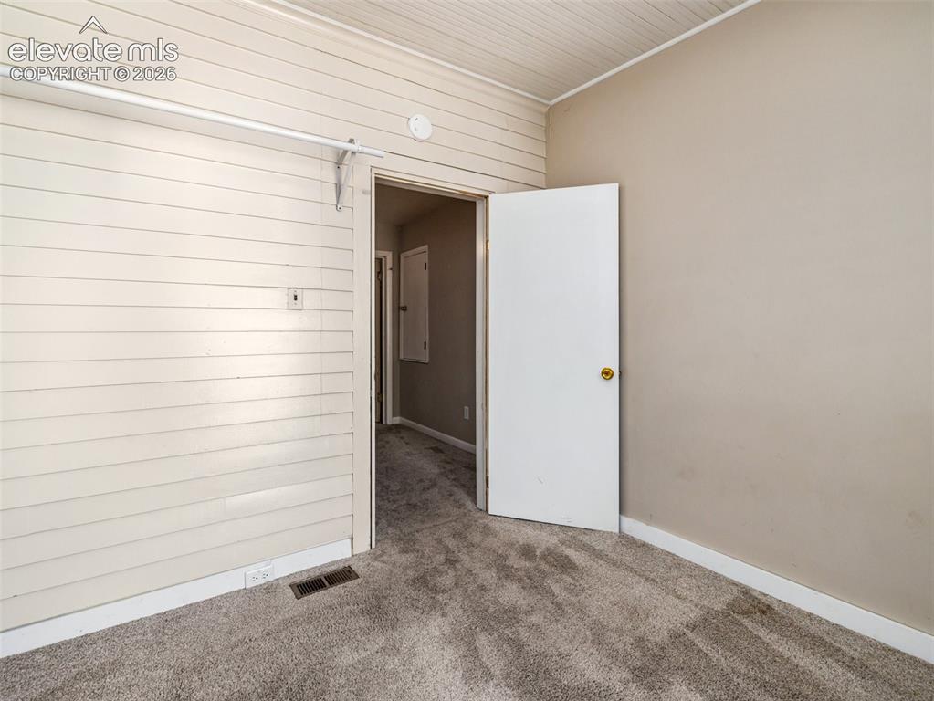 Image 16 of 22: Wall-to-wall carpeting, painted walls, and white trim