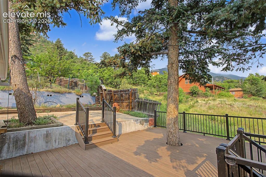 Image 27 of 27: Outdoor deck area featuring wood-finish composite decking