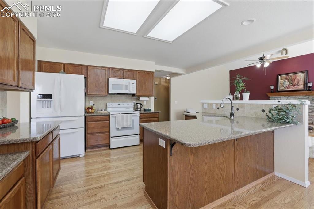 Image 18 of 48: Kitchen with beautiful hardwood floors.