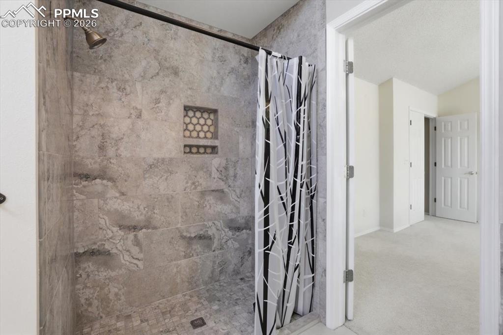 Image 27 of 48: Walk-in shower in primary bathroom.