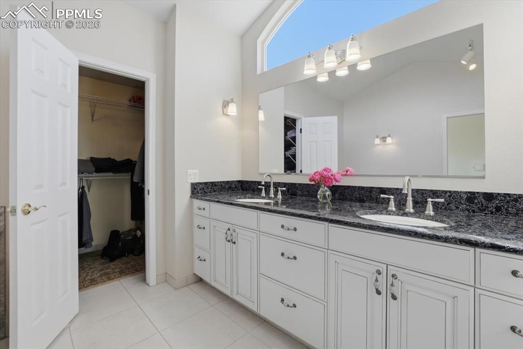 Image 28 of 48: Primary bathroom with tons of natural light and walk-in closet.