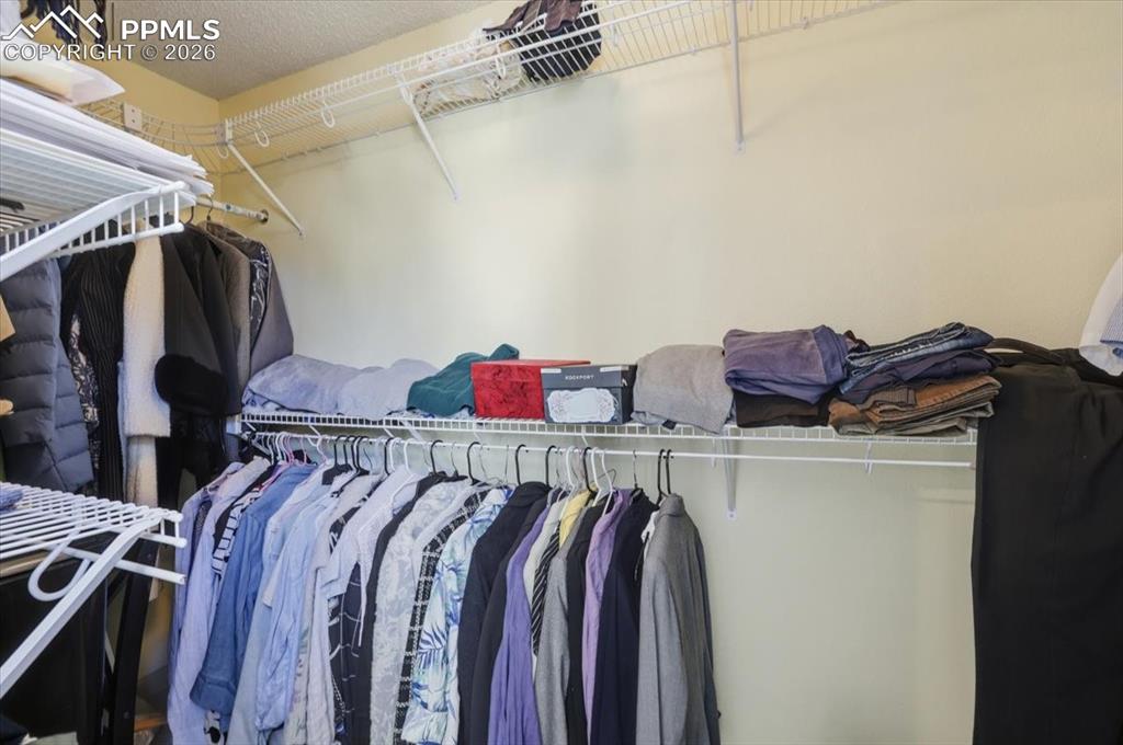 Image 29 of 48: Large walk-in closet off primary bathroom.