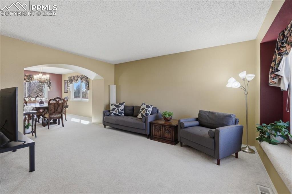 Image 9 of 48: Formal living room opens to the formal dining room.