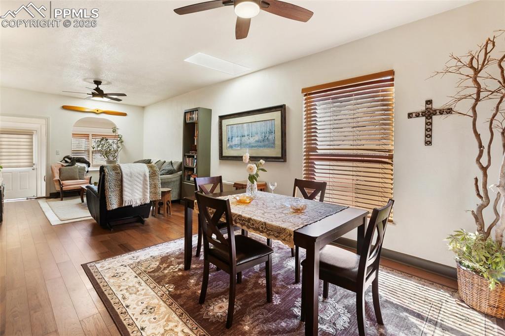 Image 12 of 37: Living room with flow towards the sunroom. LVP flooring. 