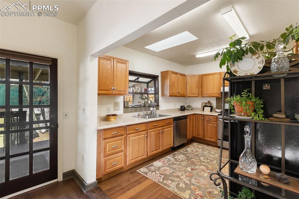 Image 14 of 37: Spacious and functional Kitchen with walkout to the deck.