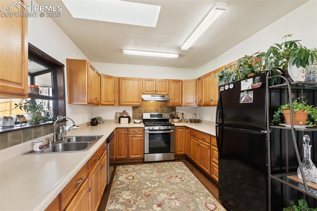 Image 15 of 37: Stainless steel appliances and plenty of cabinet space.