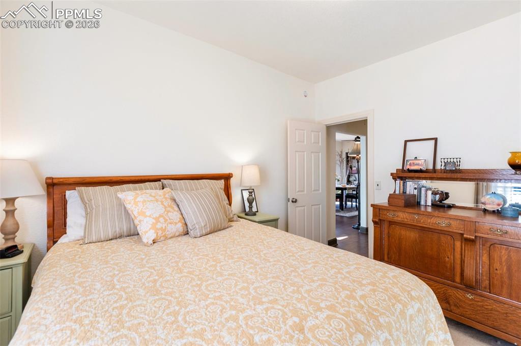 Image 25 of 37: Primary bedroom offers privacy from the main living space.