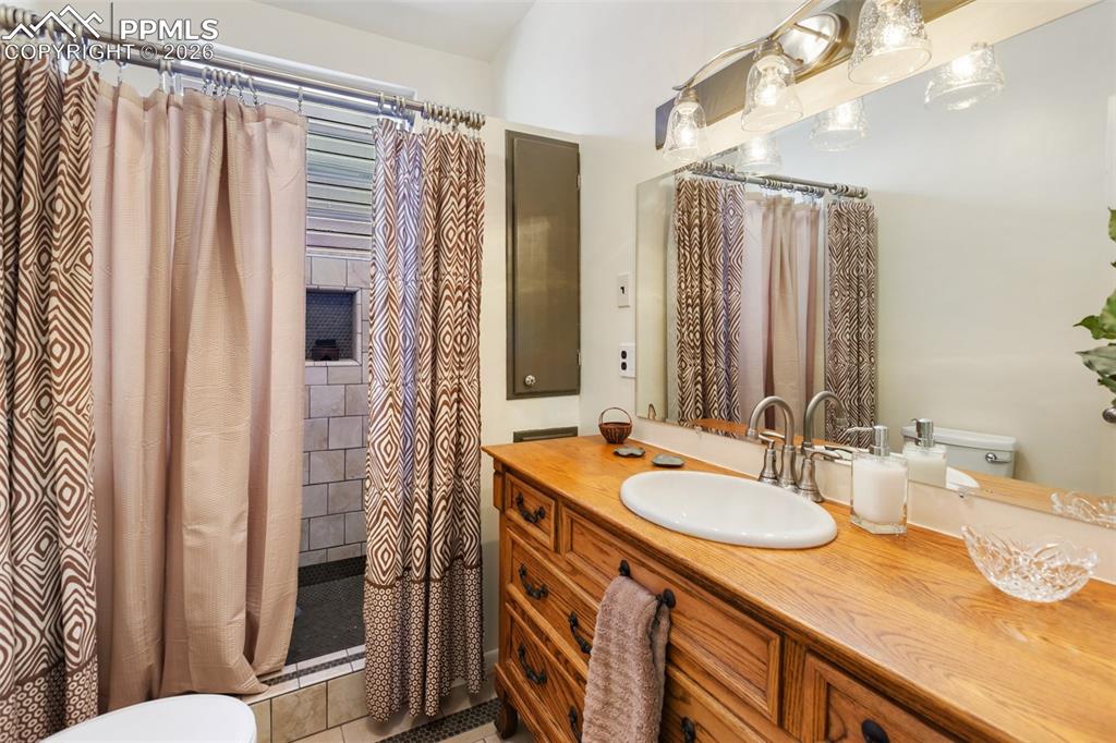 Image 27 of 37: Spacious bedroom offers room for bed, sitting area, dresser and nightstands