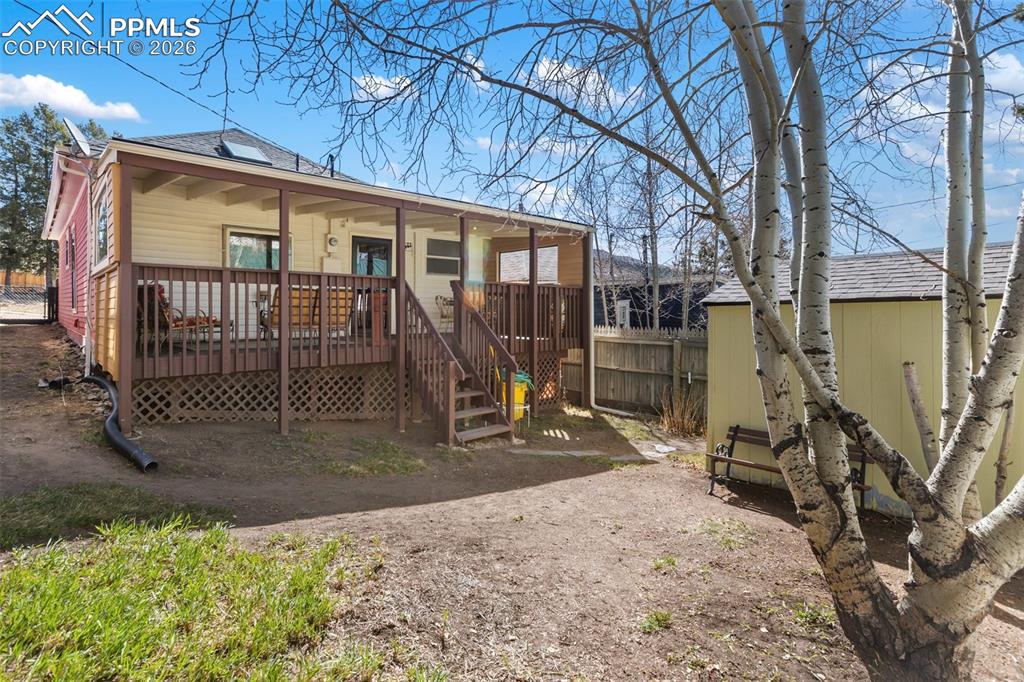 Image 30 of 37: Fully fenced backyard with storage shed.