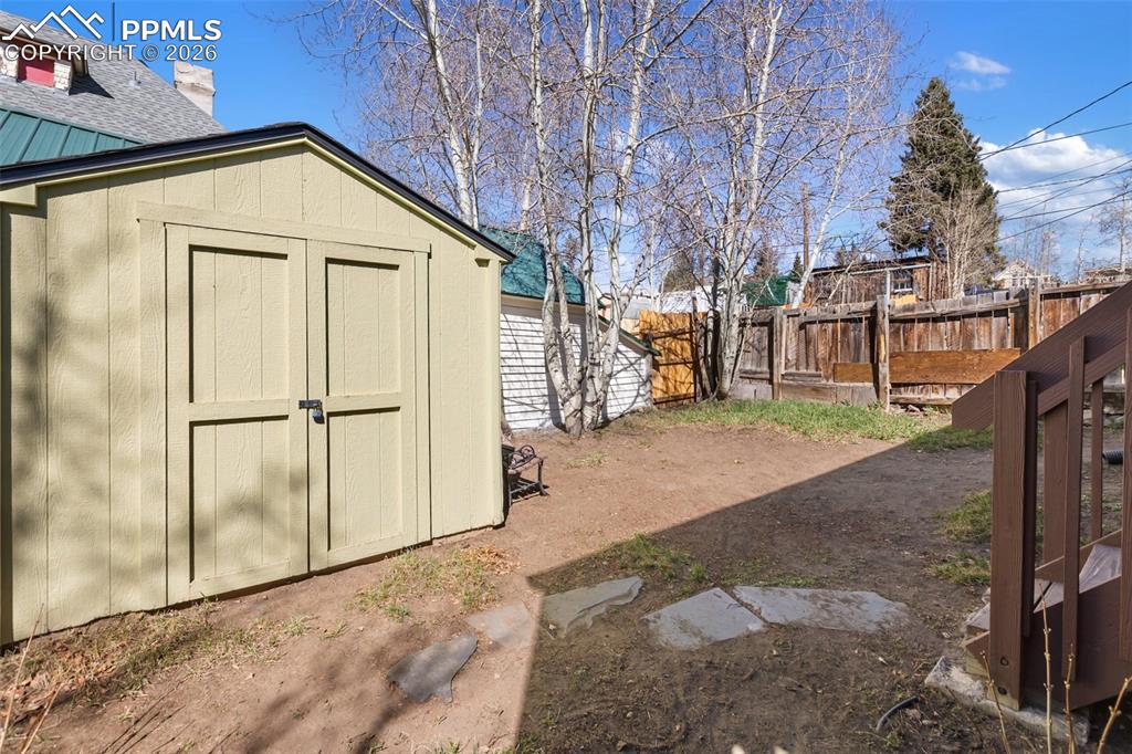 Image 34 of 37: Storage shed for all your lawn and gardening tools.