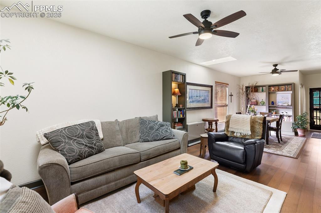 Image 6 of 37: Spacious and open living room. Ceiling fans and skylights.