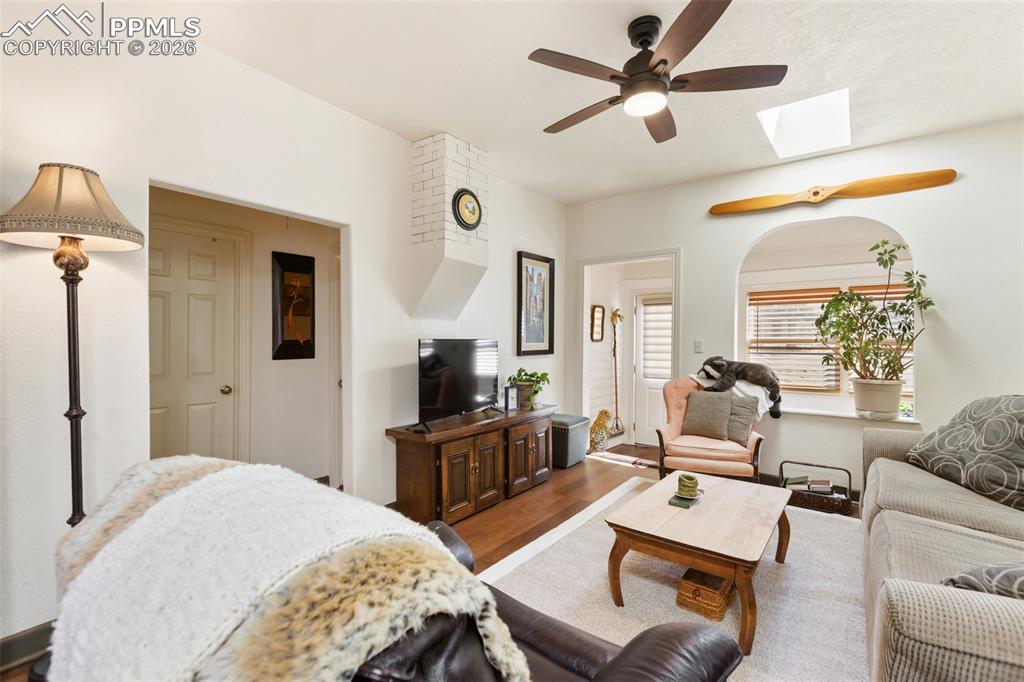 Image 7 of 37: Living room with flow towards the sunroom. LVP flooring.