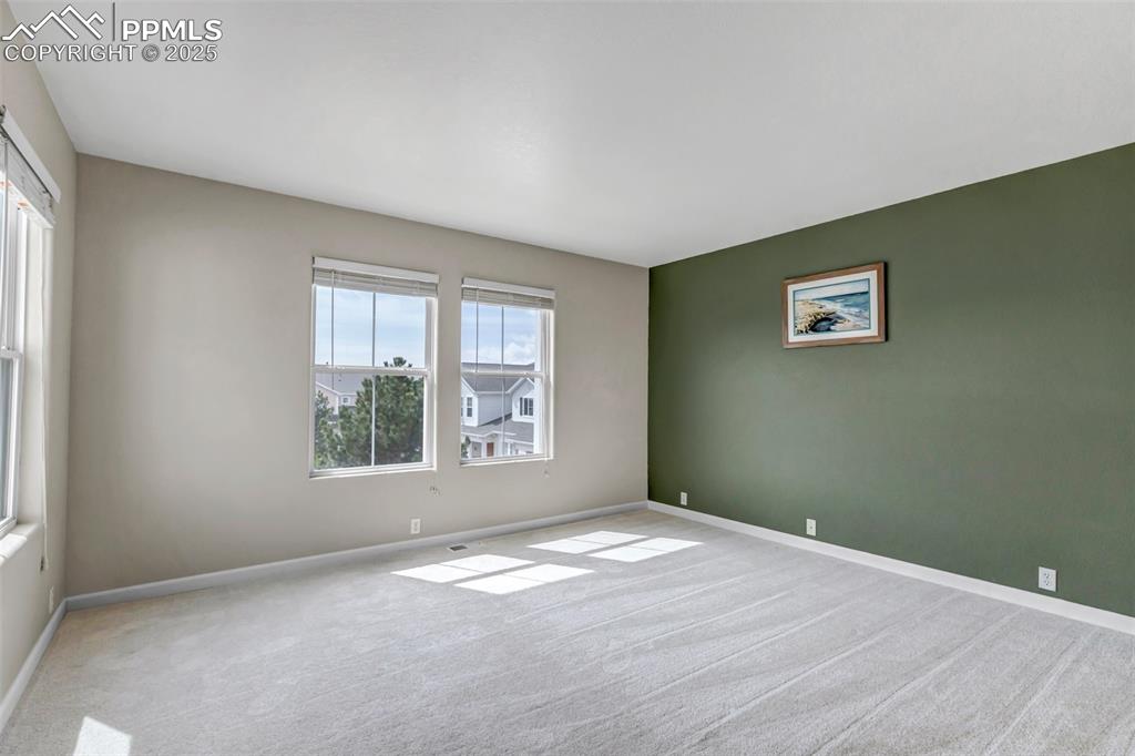 Image 14 of 46: Carpeted spare room with baseboards