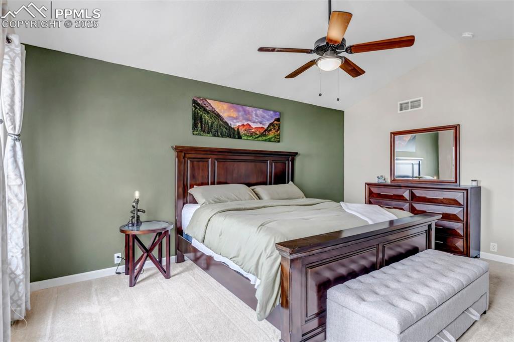 Image 24 of 46: Carpeted bedroom featuring lofted ceiling and ceiling fan