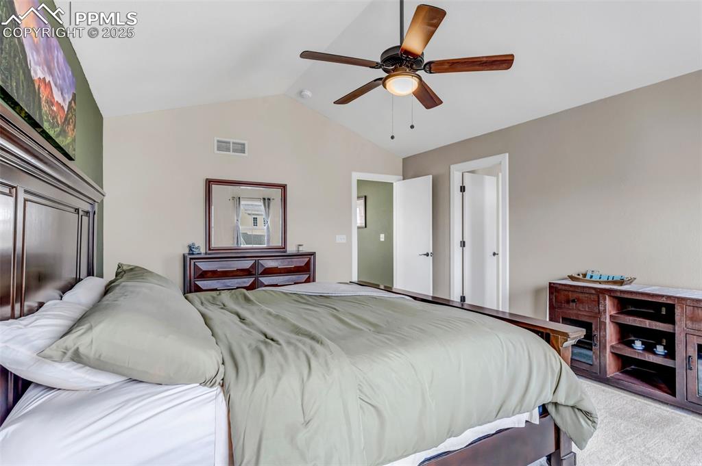 Image 25 of 46: Bedroom featuring lofted ceiling, carpet flooring, and a ceiling fan