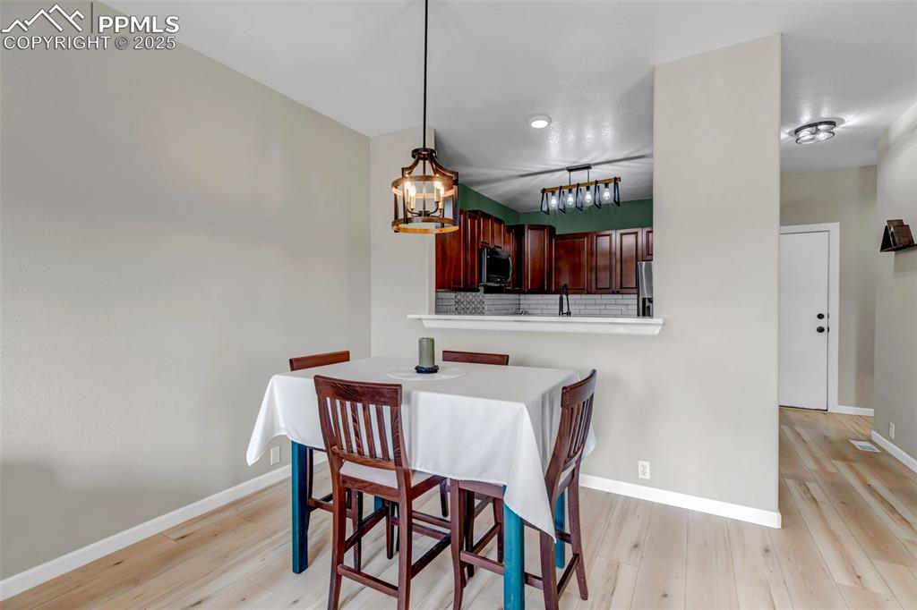 Image 35 of 46: Dining space featuring light wood-type flooring and a chandelier