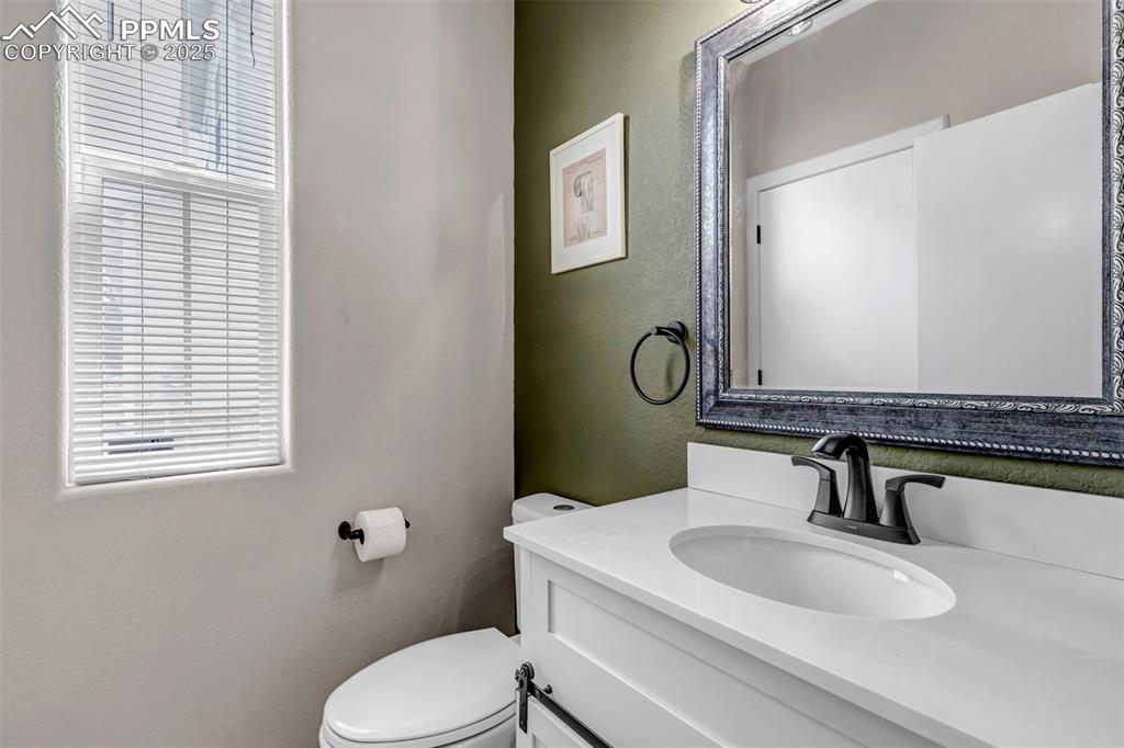 Image 42 of 46: Bathroom with vanity and a textured wall