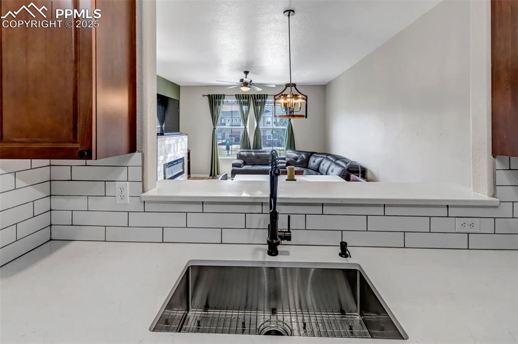 Image 43 of 46: Kitchen featuring tasteful backsplash, open floor plan, light countertops,