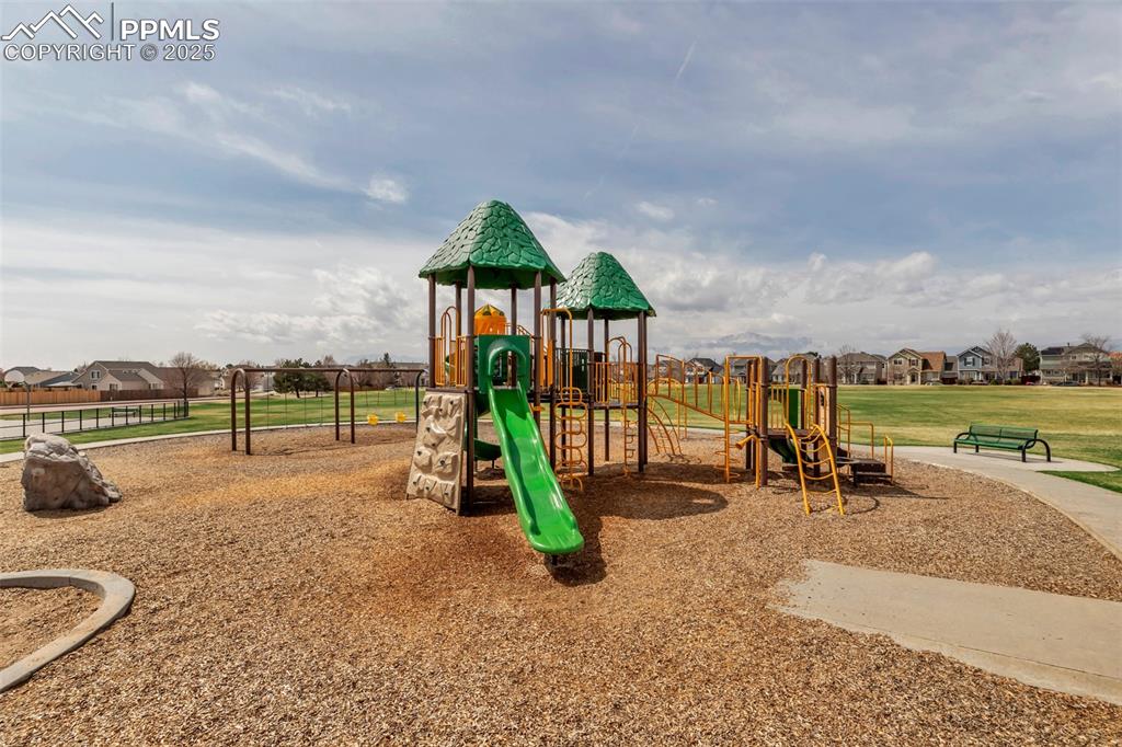 Image 44 of 46: Community playground featuring a residential view