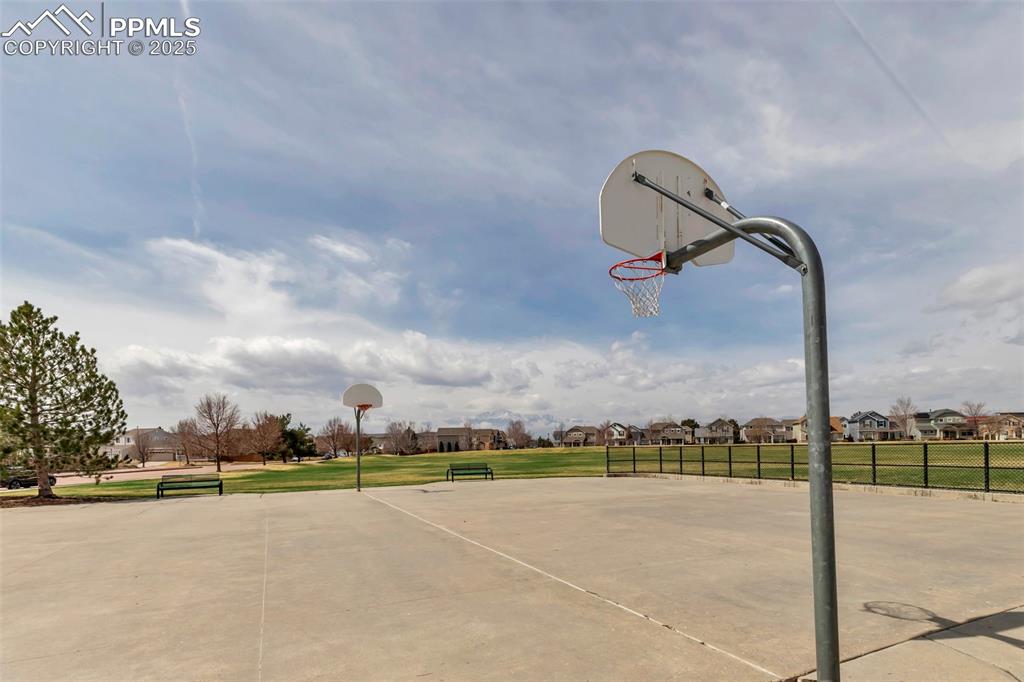 Image 46 of 46: View of basketball court featuring community basketball court and a residen