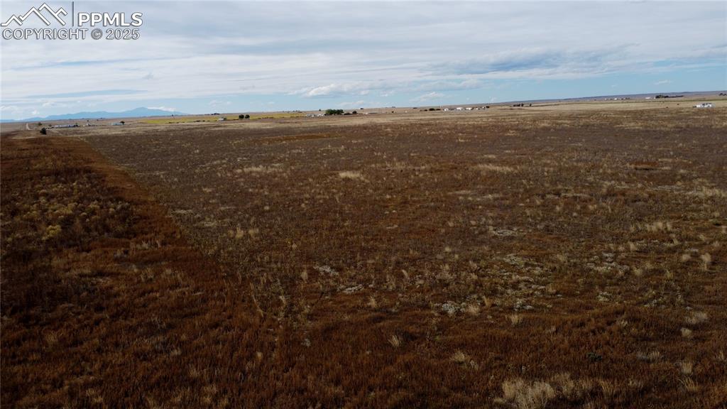 Image 16 of 21: View of undeveloped land with rural landscape and a mountainous background