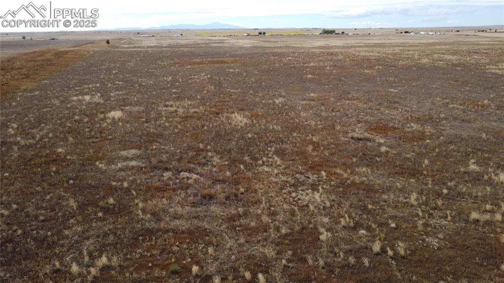 Image 18 of 21: Overview of rural landscape with a mountain backdrop