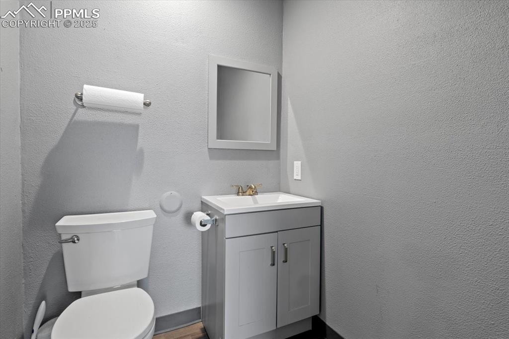 Image 7 of 14: 2nd bathroom with toilet and vanity