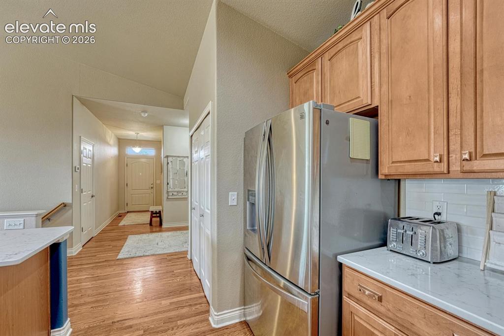Image 11 of 41: Kitchen view to entry hallway