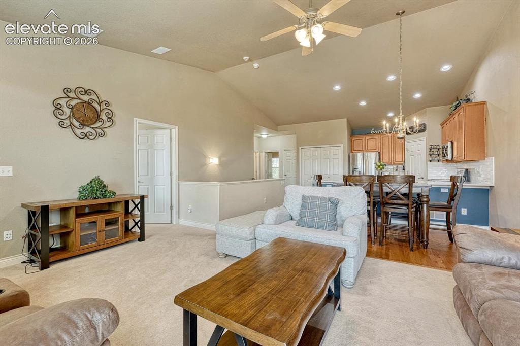 Image 14 of 41: Spacious living area featuring a vaulted ceiling, recessed lighting, and a
