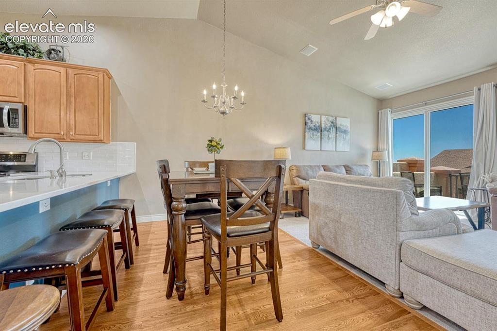 Image 17 of 41: Vaulted ceilings complement the wood-finish flooring throughout this open-c