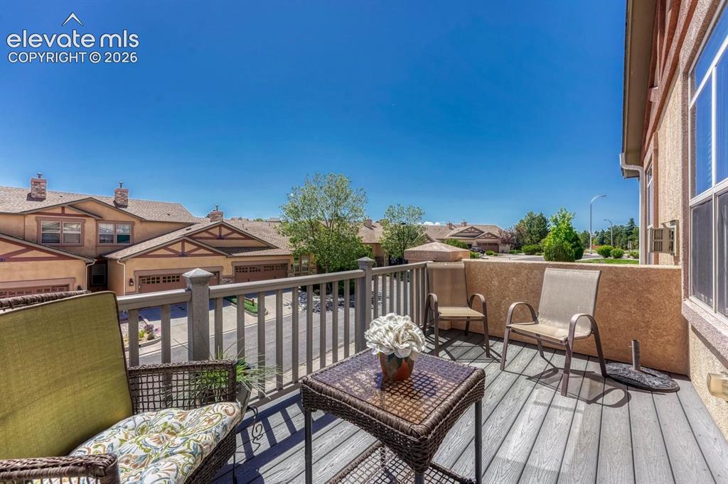 Image 18 of 41: Upper-level private balcony featuring composite decking, a sturdy railing s
