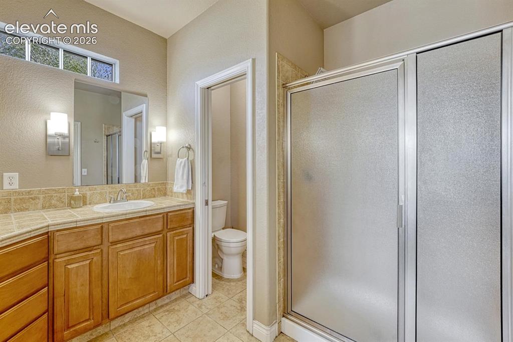 Image 23 of 41: Spacious En Suite bathroom featuring a tile-surround vanity with a double b