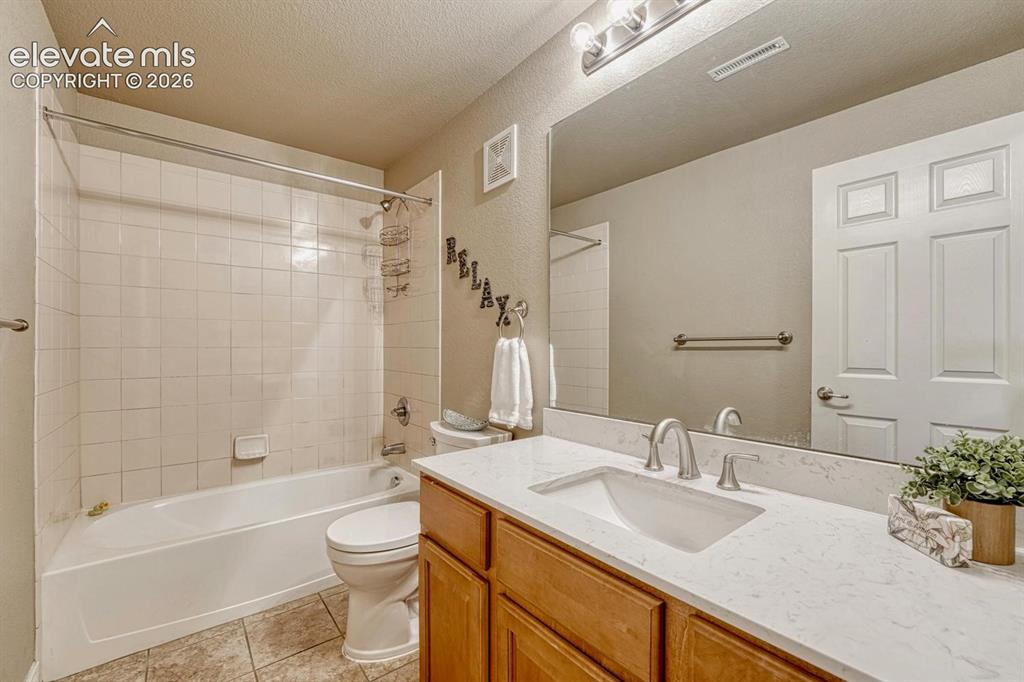 Image 40 of 41: Lower level Full Bathroom featuring a single vanity with a white solid-surf